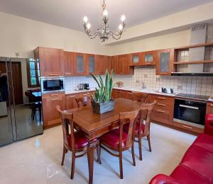 a kitchen with a wooden table and some chairs at Villa Voulgari in Ioannina +8 photos