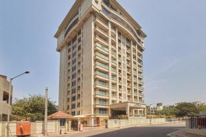 a tall building on the corner of a street at Residency Sarovar Portico in Mumbai