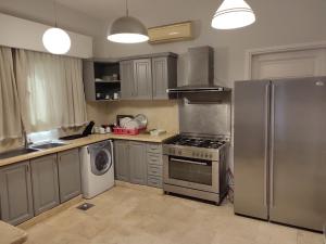 a kitchen with a stove and a refrigerator at GS 18 Villa in Hurghada