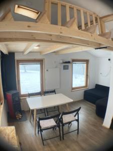 a living room with a table and a couch at Tiny house in Mislinja