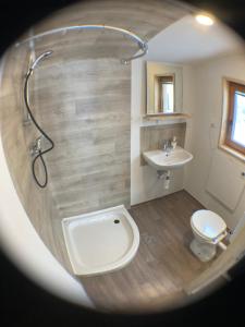 a bathroom with a toilet and a sink at Tiny house in Mislinja