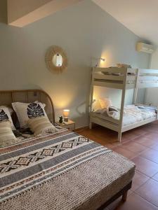 a bedroom with two beds and a bunk bed at Plage & Repos - Hermitage les bains in La Saline les Bains