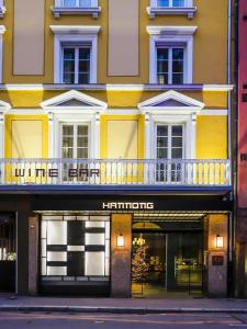 a store front of a yellow building with a balcony at HANNONG Hotel & Wine Bar in Strasbourg