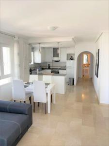 a kitchen and living room with a couch and a table at Beautiful 2 Bed Apartment on Villamartin Plaza in Villacosta