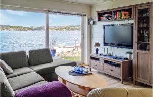 a living room with a couch and a tv at Cozy Home In Egersund With Wifi in Egersund