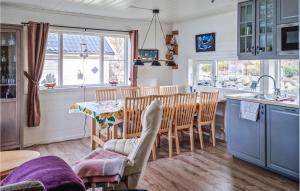 a kitchen and dining room with a table and chairs at Nice Home In Egersund With Wifi in Egersund