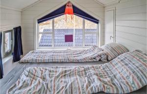 a bedroom with two beds in front of a window at Cozy Home In Egersund With Wifi in Egersund +17 photos