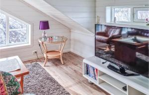 a living room with a tv and a table at Nice Home In Egersund With Wifi in Egersund