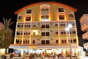 a large building with people sitting outside of it at MiTOS APART OTEL in Alanya