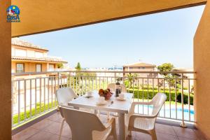 d'une table et de chaises blanches sur un balcon avec vue. dans l'établissement Apartamentos Bovalar Casa Azahar, à Alcossebre