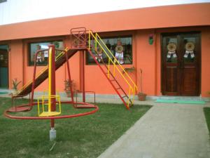 a playground with a slide in front of a building at Rains Inn Eco Hotel in Diphu