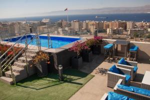 a swimming pool on the roof of a building at Baity Boutique Hotel in Aqaba