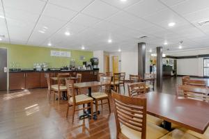 a dining room with wooden tables and chairs at Sleep Inn Henderson in Henderson