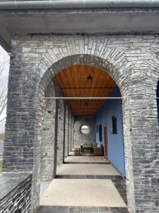 an entrance to a stone wall with an archway at Fewo Zur Wache in Nohra