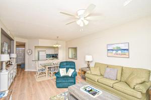 a living room with a couch and a ceiling fan at Seaside At Anastasia 202 Condo in Saint Augustine