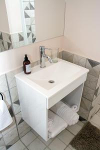 a bathroom with a white sink and a mirror at Paseo Bolivar Hotel in Azul