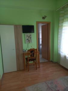 a room with a chair and a table and a television at Pensiunea Vila Dana in Cluj-Napoca +16 photos