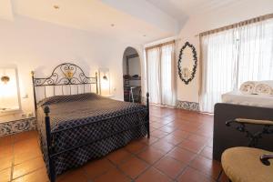 a bedroom with two beds and a tiled floor at D'Iberica Alojamento in Évora