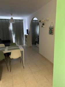a dining room and living room with a table and chairs at Il Paradiso Esiste in Costa Calma