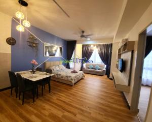 a living room with a table and a couch at Bali Residence Impian Raudah in Melaka