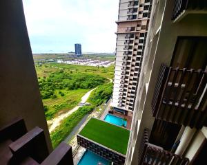 a view from the balcony of a apartment building with a pool at Bali Residence Impian Raudah in Melaka