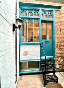 a blue door on the side of a building at Refurbished Seaside Retreat in the Heart of Cromer in Cromer