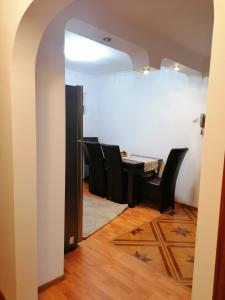 a dining room with a table and black chairs at Acasă in Drobeta-Turnu Severin