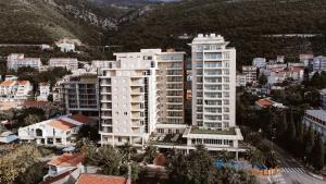 an aerial view of a city with tall buildings at Hotel AMI Budva Petrovac in Petrovac na Moru