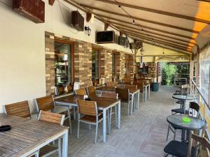 a restaurant with wooden tables and chairs and a unintention at Apartmán KATARINA v Penzióne pod Smrekom in Martin