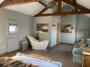sala de estar con bañera y sofá en The Annex: 2 bedroom cottage, countryside, peaceful getaway with garden en Easingwold