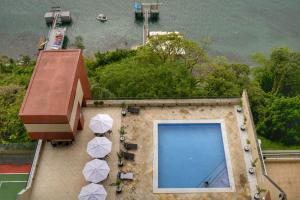 an overhead view of a building with a large swimming pool at Sol Victoria Marina in Salvador