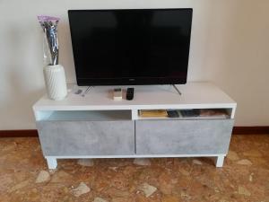 a white entertainment center with a flat screen tv on it at Panorama in Milan