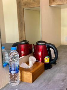 a bottle of water sitting next to two coffee pots at Kohyao Non Bay in Ban Nai Wat