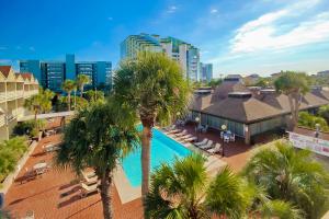 an aerial view of a resort with a swimming pool and palm trees at The Condo on Ocean Blvd in Myrtle Beach