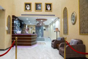 a lobby with couches and a salon with a red ribbon at La Rive Hotels & Suites in Dammam