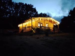 a house lit up at night with lights on it at Eco Lodge nella natura "La Grande Quercia" in Calangianus
