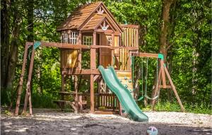 a wooden playground with a slide and a gazebo at Nice Home In Frombork With Outdoor Swimming Pool, Wifi And 1 Bedrooms in Frombork