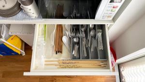 a drawer filled with utensils in a refrigerator at MARBLE B&B in Kashima