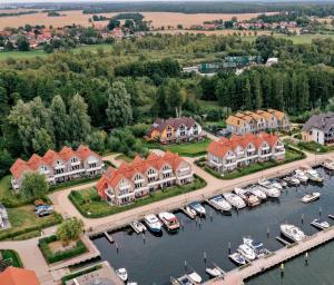 an aerial view of a marina with houses and boats at Hafendorf Haus 7_ Apartment 4 in Plau am See