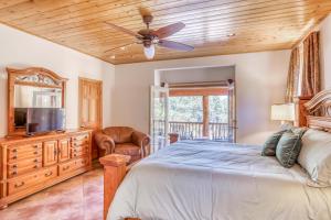 a bedroom with a bed and a ceiling fan at 077 - Lucky 7s - Meredith Lodging in Big Bear Lake