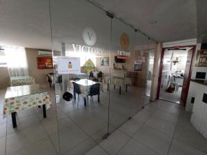 a room with a table and a clock on the wall at Victory Flat Tambaú BR in João Pessoa