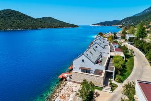 an aerial view of a house on the shore of a lake at Doria Hotel Yacht Club Kaş in Kaş