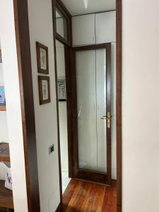 a glass door in a room with a wooden floor at Casa Fiocco di Neve in Madonna di Campiglio