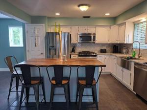 a kitchen with a wooden table and four chairs at KL Retreat 4BR4BTH with Jacuzzi and game room! in Key Largo