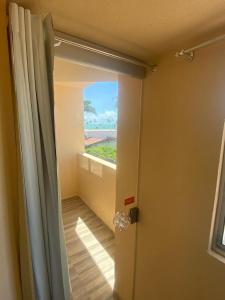 an open door to a room with a window at Hotel Palmanova in Maceió