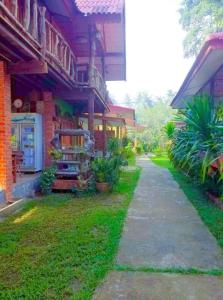 a building with a sidewalk in front of it at Coconut corner in Ko Yao Noi