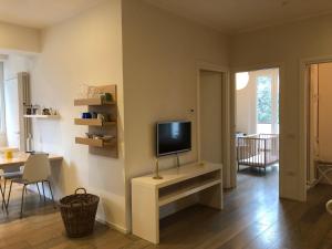 a living room with a tv sitting on a table at Suite Mare Centro in Pesaro