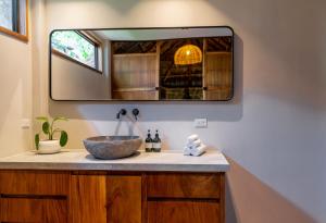 a bathroom with a sink and a mirror at Blue Mist Hotel- Adults Only in Santa Teresa Beach