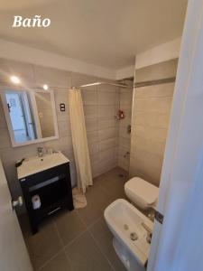 a bathroom with a toilet and a sink at Guzmán in Punta del Este