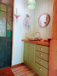 a bathroom with a sink and a mirror at Los Lirios in Los Hornillos